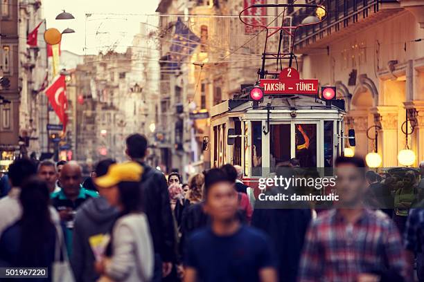 historic red tram on crowded istiklal avenue in taksim, istanbul - beyoglu tram stock pictures, royalty-free photos & images