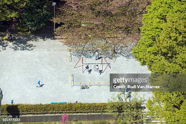 children playing on swing - aerial view of childs playground stock pictures, royalty-free photos & images