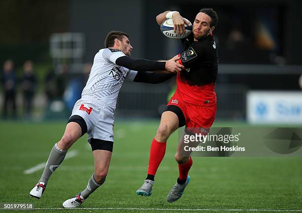 Mike Ellery of Saracens is tackled by Florian Denos of Oyonnax during the European Rugby Champions Cup match between Saracens and Oyonnax at Allianz...