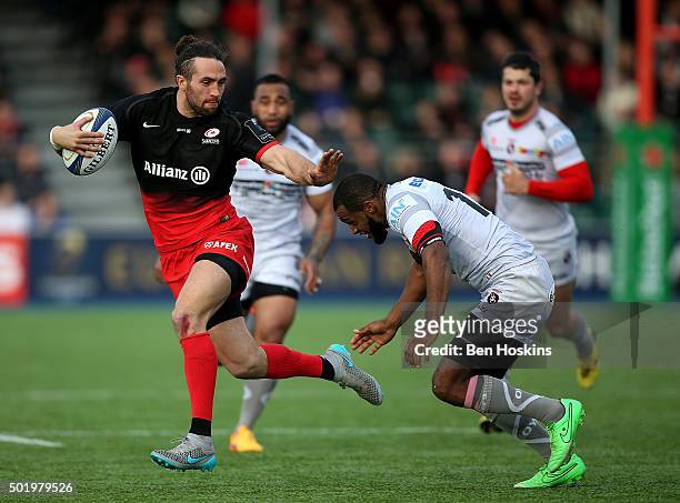 Mike Ellery of Saracens is tackled by Daniel Ikpefan of Oyonnax during the European Rugby Champions Cup match between Saracens and Oyonnax at Allianz...