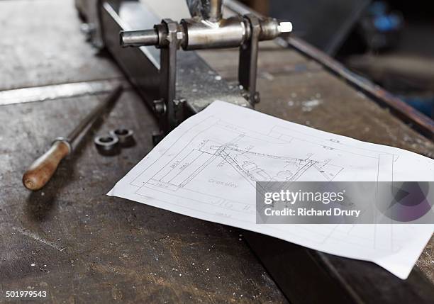 drawings and frame jig in bicycle makers workshop - workbench stock pictures, royalty-free photos & images