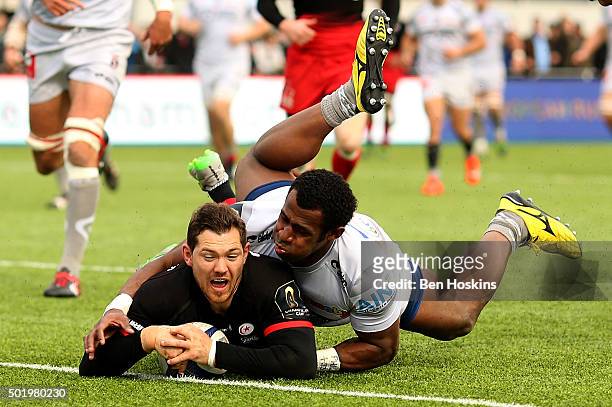 Alex Goode of Saracens breaks clear from Uwa Tawalo of Oyonnax to score a try during the European Rugby Champions Cup match between Saracens and...