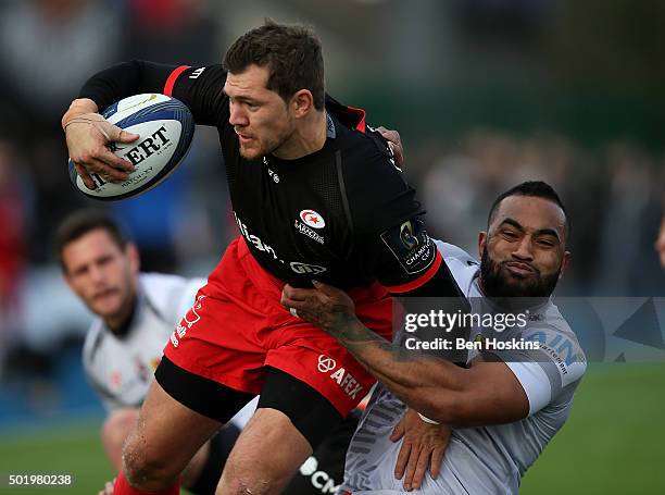 Alex Goode of Saracens is tackled by Uwa Tawalo of Oyonnax during the European Rugby Champions Cup match between Saracens and Oyonnax at Allianz Park...