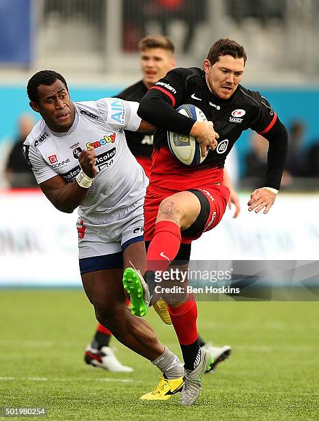 Alex Goode of Saracens breaks clear from Uwa Tawalo of Oyonnax to score a try during the European Rugby Champions Cup match between Saracens and...