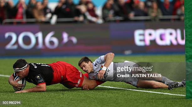 Saracens' hooker from England Jamie George scores a try as Oyonnax's scrum-half from France Julien Blanc makes a tackle during the European Rugby...