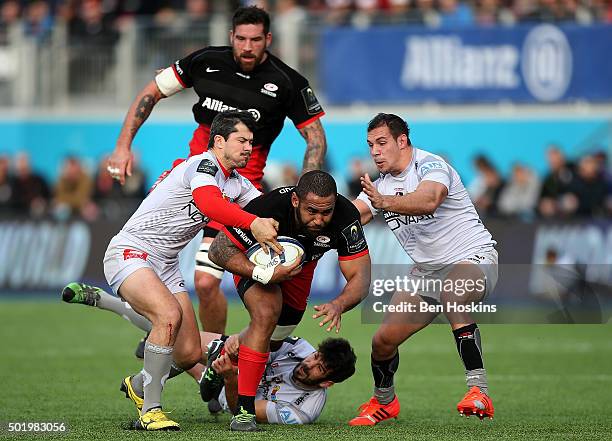 Samuela Vunisa of Saracens is tackled during the European Rugby Champions Cup match between Saracens and Oyonnax at Allianz Park on December 19, 2015...