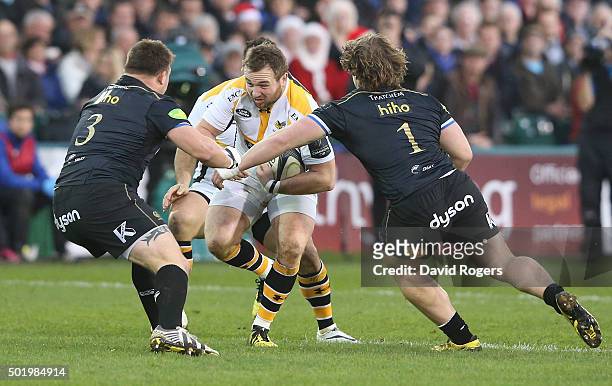 Matt Mullan of Wasps takes on David Wilson and Nick Auterac during the European Rugby Champions Cup match between Bath and Wasps at the Recreation...