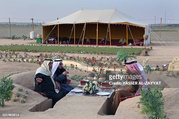 Kuwaiti men hang out at a winter camp in Kuwaits desert, some 120 km Northwest of Kuwait City, on December 19, 2015. The official camping season in...