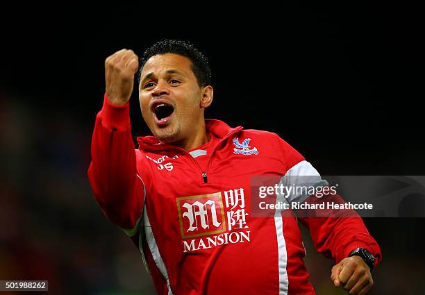 Assistant coach John Salako celebrates at the final whistle during the Barclays Premier League match between Stoke City and Crystal Palace at the...