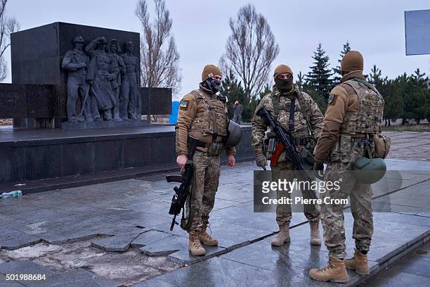 Members of the Azov battalion stand guard near a monument of the former Soviet Union on December 19, 2015 in Mariupol, Ukraine.