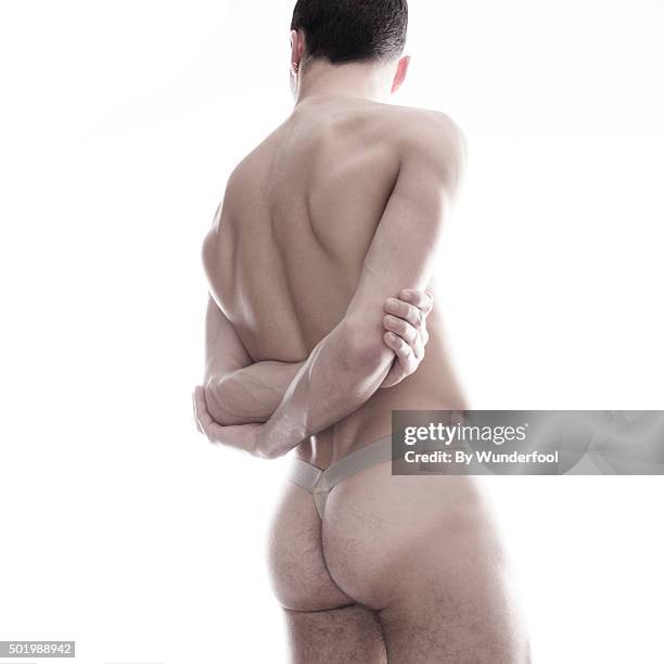 male ballet dancer posing against backlight - hairy bum 個照片及圖片檔