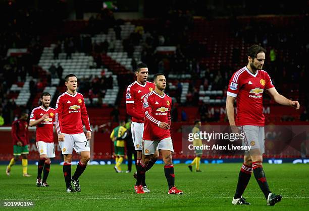 Manchester United players leave the pitch after their team's 1-2 defeat in the Barclays Premier League match between Manchester United and Norwich...