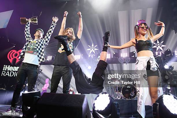 Joe Jonas, Joe Lawless, Cole Whittle, and JinJoo Lee of DNCE take a bow during the 2015 Y100 Jingle Ball at BB&T Center on December 18, 2015 in...