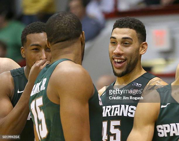 Denzel Valentine of the Michigan State Spartans celebrates with teammates moments before defeating the Northeastern Huskies, 58-78 on December 19,...