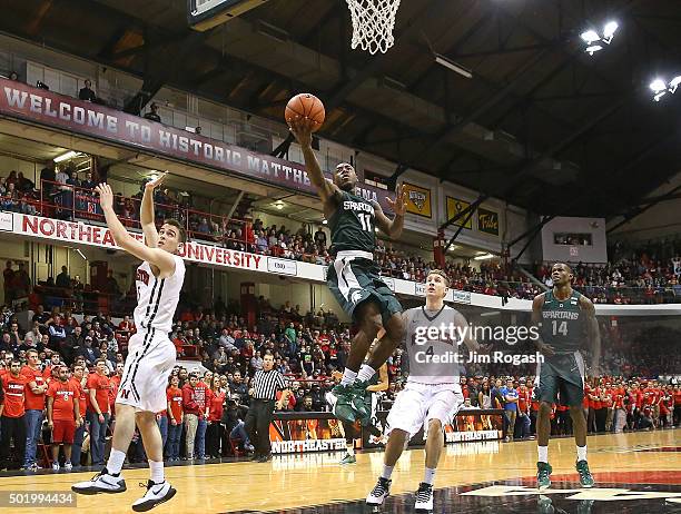 Lourawls Nairn Jr. #11 of the Michigan State Spartans scores by David Walker of the Northeastern Huskies in the second half on December 19, 2015 at...