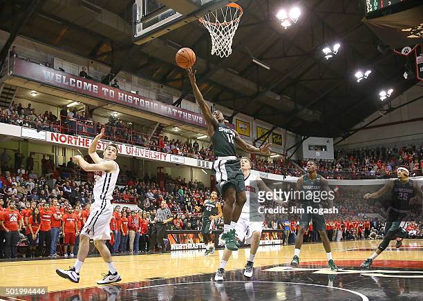 Lourawls Nairn Jr. #11 of the Michigan State Spartans scores by David Walker of the Northeastern Huskies in the second half on December 19, 2015 at...