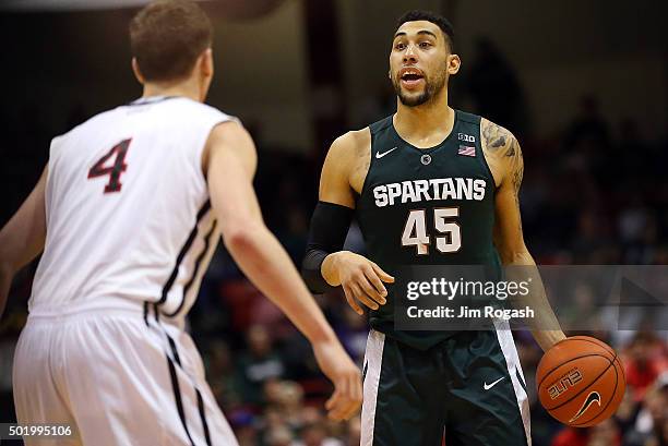 Denzel Valentine of the Michigan State Spartans looks for an open man as David Walker of the Northeastern Huskies defends in the second half on...