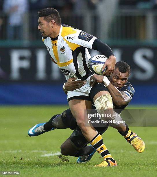 Charles Piutau of Wasps is held by Semesa Rokoduguni during the European Rugby Champions Cup match between Bath and Wasps at the Recreation Ground on...