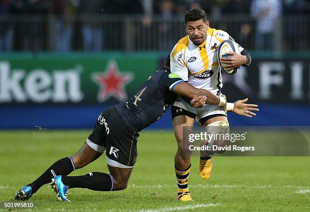 Charles Piutau of Wasps is held by Semesa Rokoduguni during the European Rugby Champions Cup match between Bath and Wasps at the Recreation Ground on...