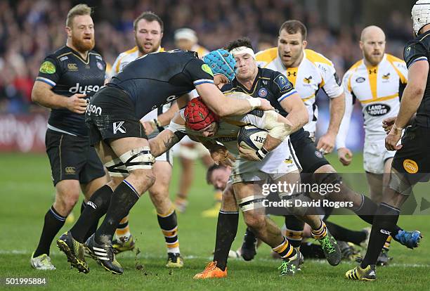 James Haskell of Wasps is stopped by David Denton and Francois Louw during the European Rugby Champions Cup match between Bath and Wasps at the...
