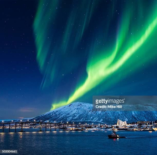 aurora borealis over tromso port - tromsö stock-fotos und bilder