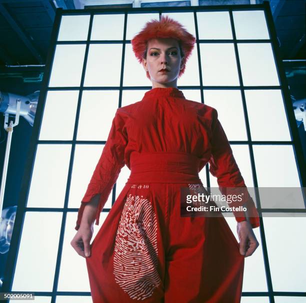English singer and actress Toyah Willcox wearing a red trouser suit with a fingerprint motif, 1980.