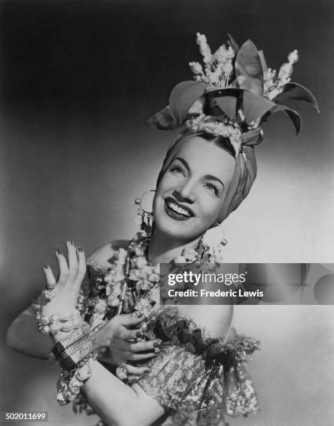 Portuguese-Brazilian singer, dancer and actress, Carmen Miranda , in one of her trademark outfits, circa 1940.