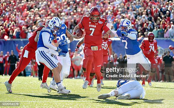 Quarterback Travis Wilson of the Utah Utes runs with the ball for a touchdown against the Brigham Young Cougars during the Royal Purple Las Vegas...