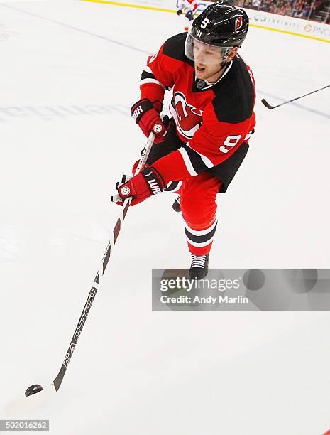 Jiri Tlusty of the New Jersey Devils plays the puck against the Florida Panthers during the game at the Prudential Center on December 17, 2015 in...