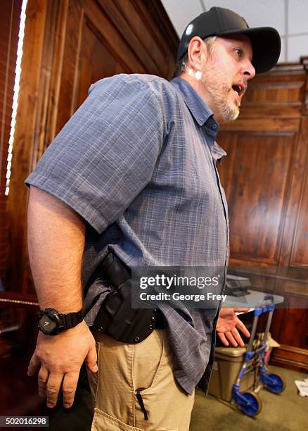 Damon Thueson shows a holster at a gun concealed carry permit class put on by "USA Firearms Training" on December 19, 2015 in Provo, Utah. Demand for...