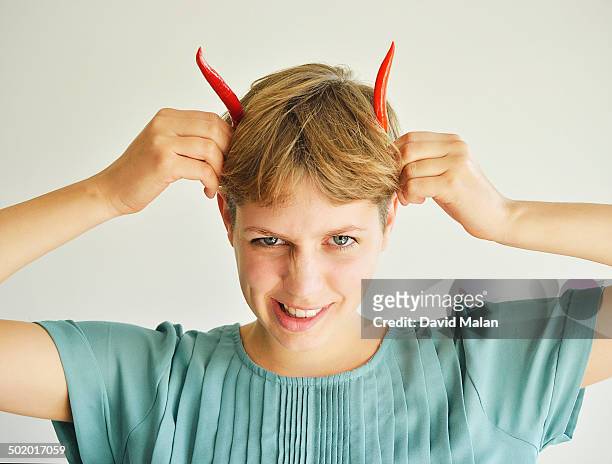 young woman suggesting horns with chilli pepers - horn of africa stock-fotos und bilder