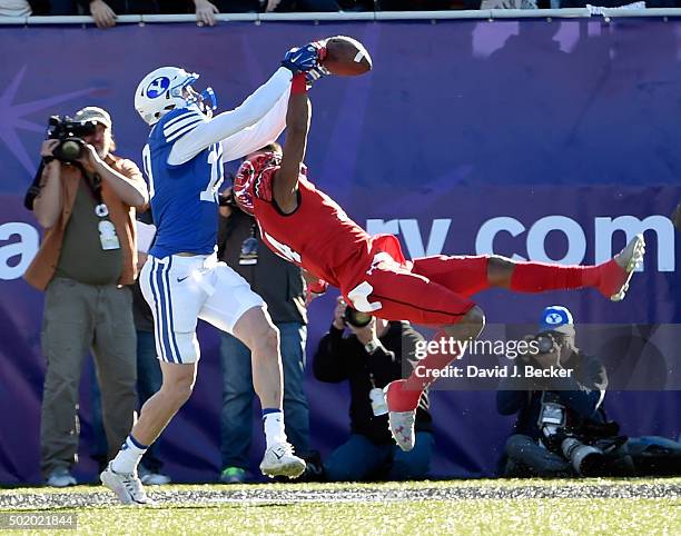 Brian Allen of the Utah Utes breaks up a catch by Mitch Mathews of the Brigham Young Cougars during the Royal Purple Las Vegas Bowl at Sam Boyd...