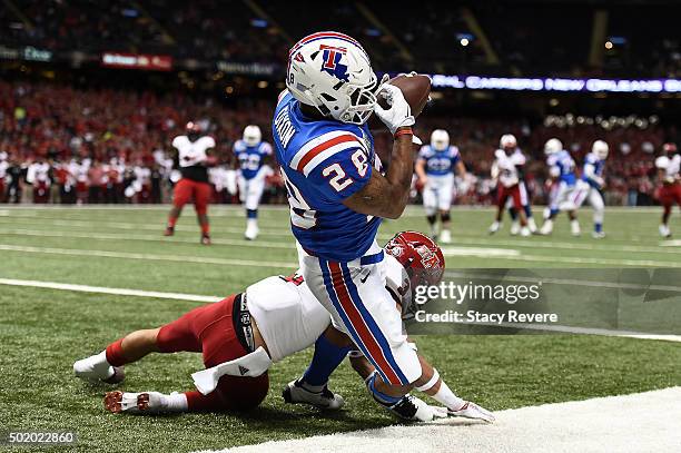 Kenneth Dixon of the Louisiana Tech Bulldogs catches a pass for a touchdown against Rocky Hayes of the Arkansas State Red Wolves during the first...