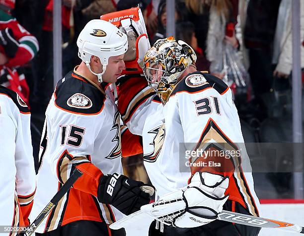 Ryan Getzlaf and Frederik Andersen of the Anaheim Ducks celebrate the win over t he New Jersey Devils on December 19, 2015 at Prudential Center in...