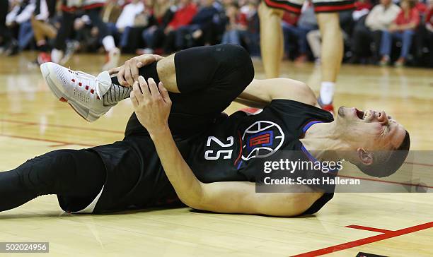 Austin Rivers of the Los Angeles Clippers falls to the court after a play against the Houston Rockets during their game at Toyota Center on December...