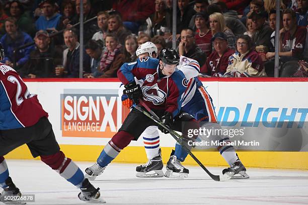 Matt Duchene of the Colorado Avalanche fights for position against Nikita Nikitin of the Edmonton Oilers at the Pepsi Center on December 19, 2015 in...