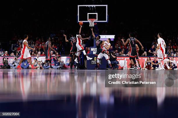 Kadeem Allen of the Arizona Wildcats lays up a shot past Patrick McCaw of the UNLV Rebels during the second half of the college basketball game at...