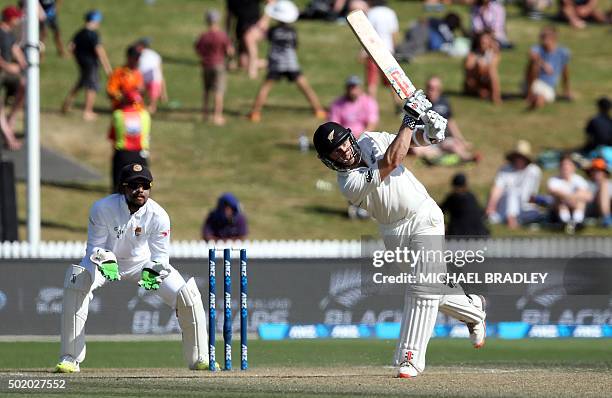 Kane Williamson of New Zealand plays a shot in front of Dinesh Chandimal of Sri Lanka on day three of the second Test cricket match between New...