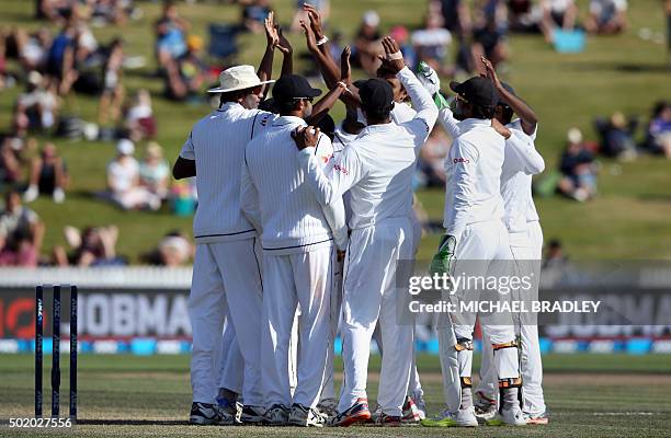 Sri Lanka celebrate after taking the wicket of Mitchell Santner of New Zealand on day three of the second Test cricket match between New Zealand and...