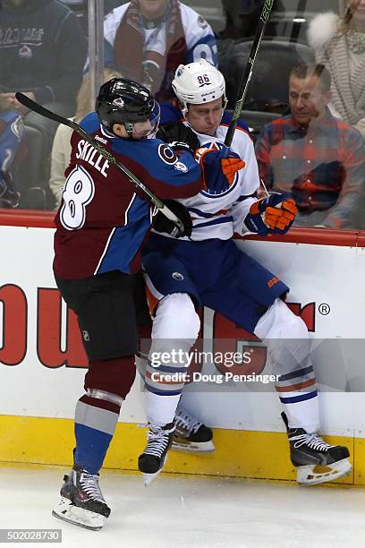 Jack Skille of the Colorado Avalanche puts a hit on Nikita Nikitin of the Edmonton Oilers at Pepsi Center on December 19, 2015 in Denver, Colorado....