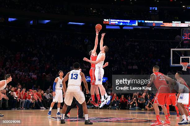 Jakob Poeltl of the Utah Utes and Marshall Plumlee of the Duke Blue Devils jump for the opening tip during the Ameritas Insurance Classic at Madison...