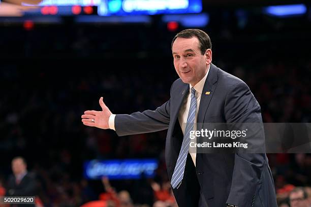 Head Coach Mike Krzyzewski of the Duke Blue Devils smiles at a referee following a play against the Utah Utes during the Ameritas Insurance Classic...