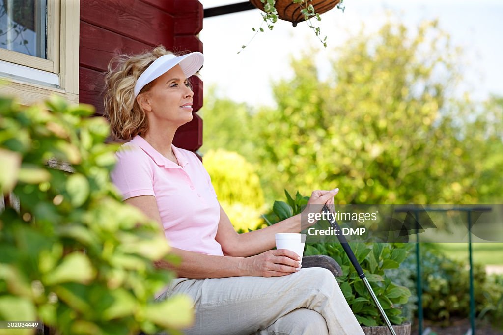 Female golfer resting after a game