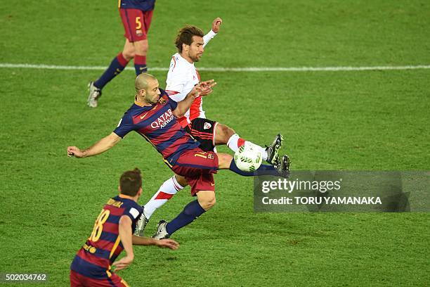 Barcelona defender Javier Mascherano and River Plate midfielder Leonardo Ponzio compete for the ball during the Club World Cup football final in...