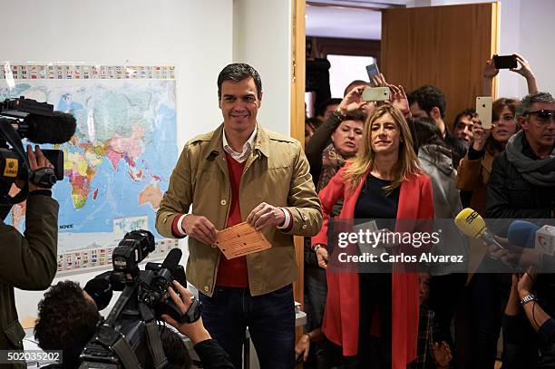 Leader of Spain's Socialist Party and candidate for general elections Pedro Sanchez and his wife Begona Fernandez cast their votes during General...