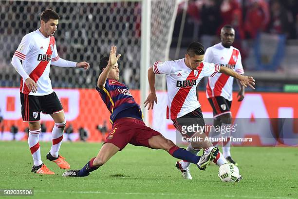 Matias Kranevitter of River Plate and Sergio Busquets of FC Barcelona compete for the ball during the final match between River Plate and FC...