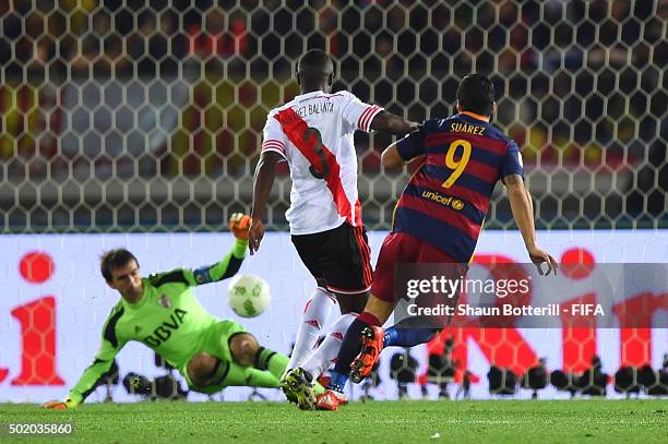 Luis Suarez of Barcelona scores his team's second goal despite the challenge from Eder Balanta of River Plate during the FIFA Club World Cup Final...