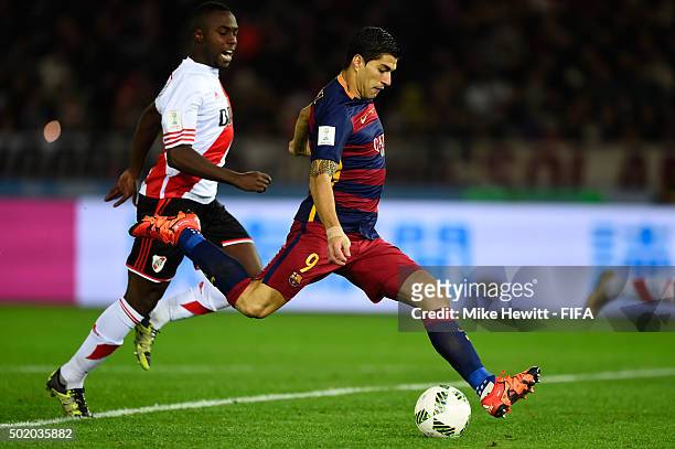 Luis Suarez of Barcelona scores his team's second goal despite the challenge from Eder Balanta of River Plate during the FIFA Club World Cup Final...