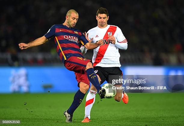Javier Mascherano of Barcelona clears the ball as Lucas Alario of River Plate closes in during the FIFA Club World Cup Final between River Plate and...