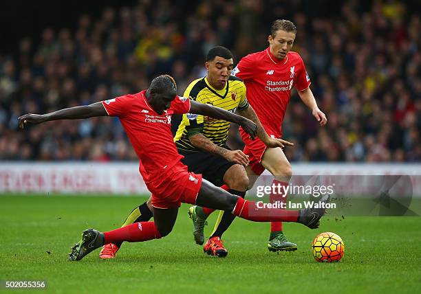 Troy Deeney of Watford takes on Mamadou Sakho and Lucas Leiva of Liverpool during the Barclays Premier League match between Watford and Liverpool at...